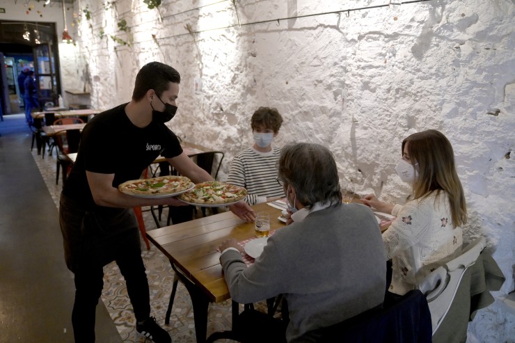 Unas personas cenando con mascarilla en el interior de un restaurante (EP).