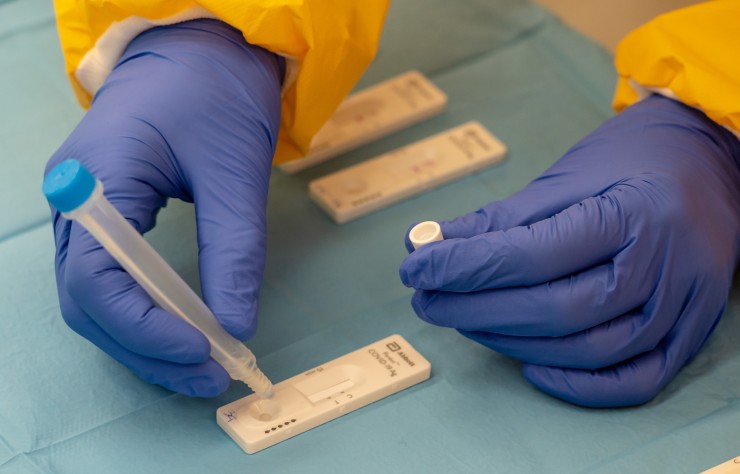 Un sanitario comprueba el resultado de un test de antígenos. / EDUARDO BRIONES - EUROPA PRESS