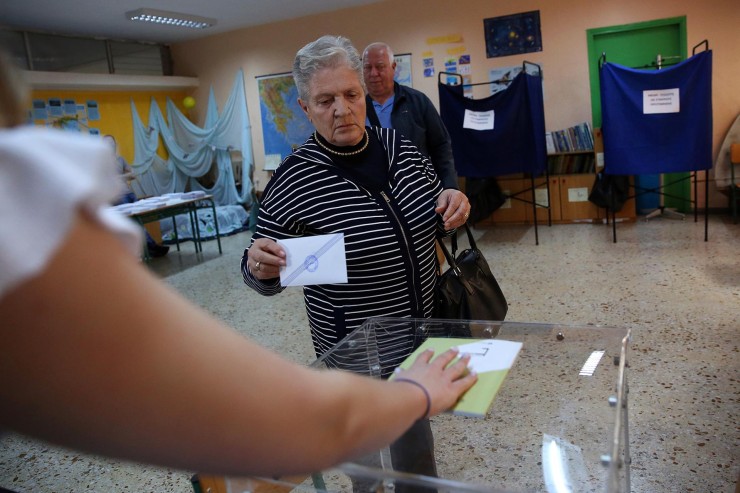 Una mujer emitiendo su voto en un colegio electoral de Atenas, Grecia. / EFE